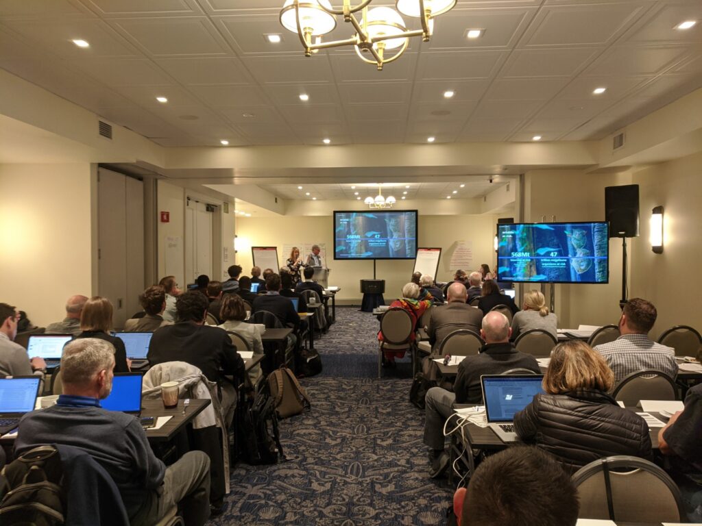 Photo of a presentation happening in a ballroom