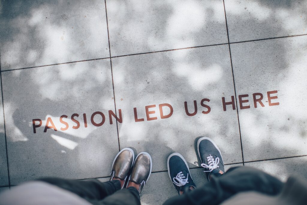 image with two people standing and the words passion let us here