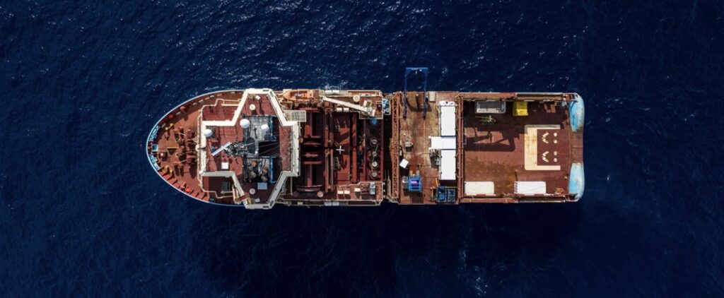 Area photo of a large boat in the water and on the far end there are two smiley faces